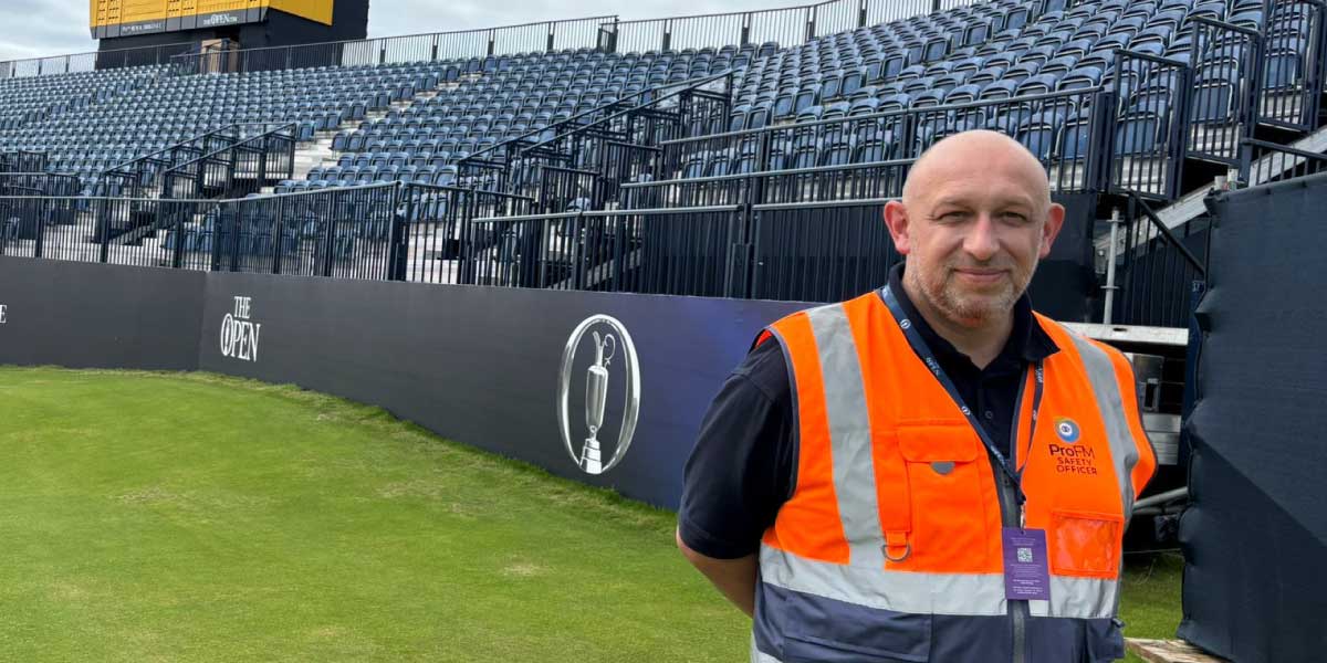 ProFM safety officer wearing an orange and grey high-visibility vest in an empty sports stadium