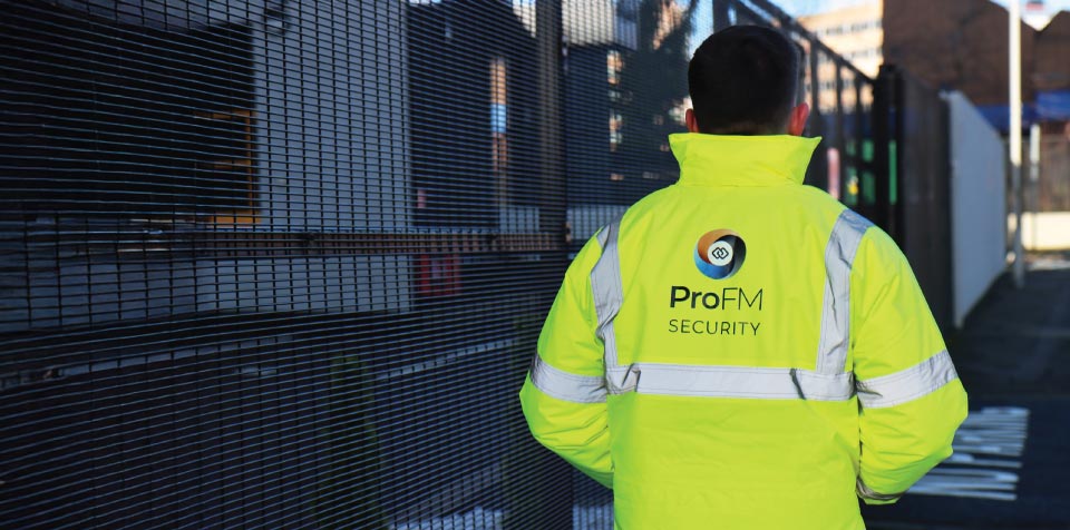 ProFM Security officer carrying out a site patrol as part of a hybrid fire watch and security service at a commercial facility.