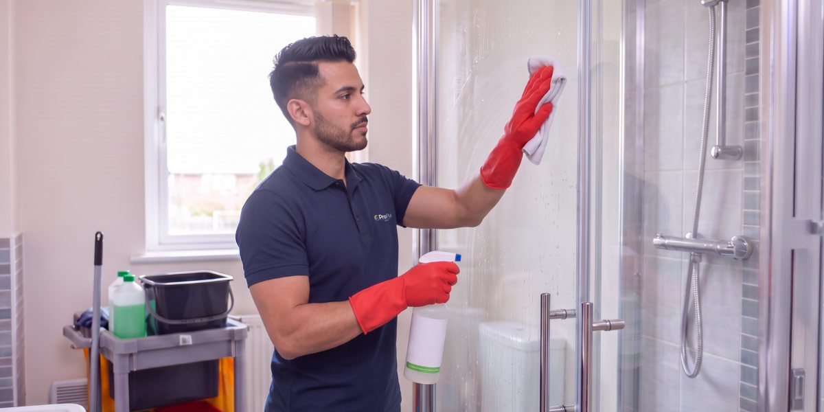 Professional cleaner carrying out deep cleaning within a residential property as part of a property management cleaning service.